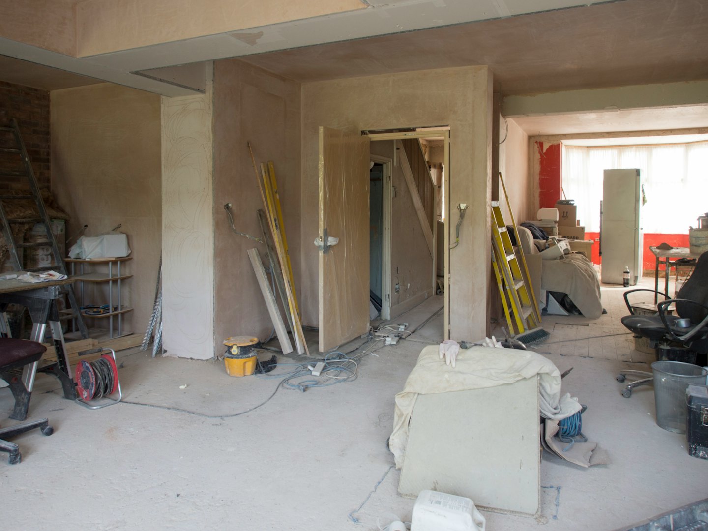 Home renovation room with exposed brick and construction tools.